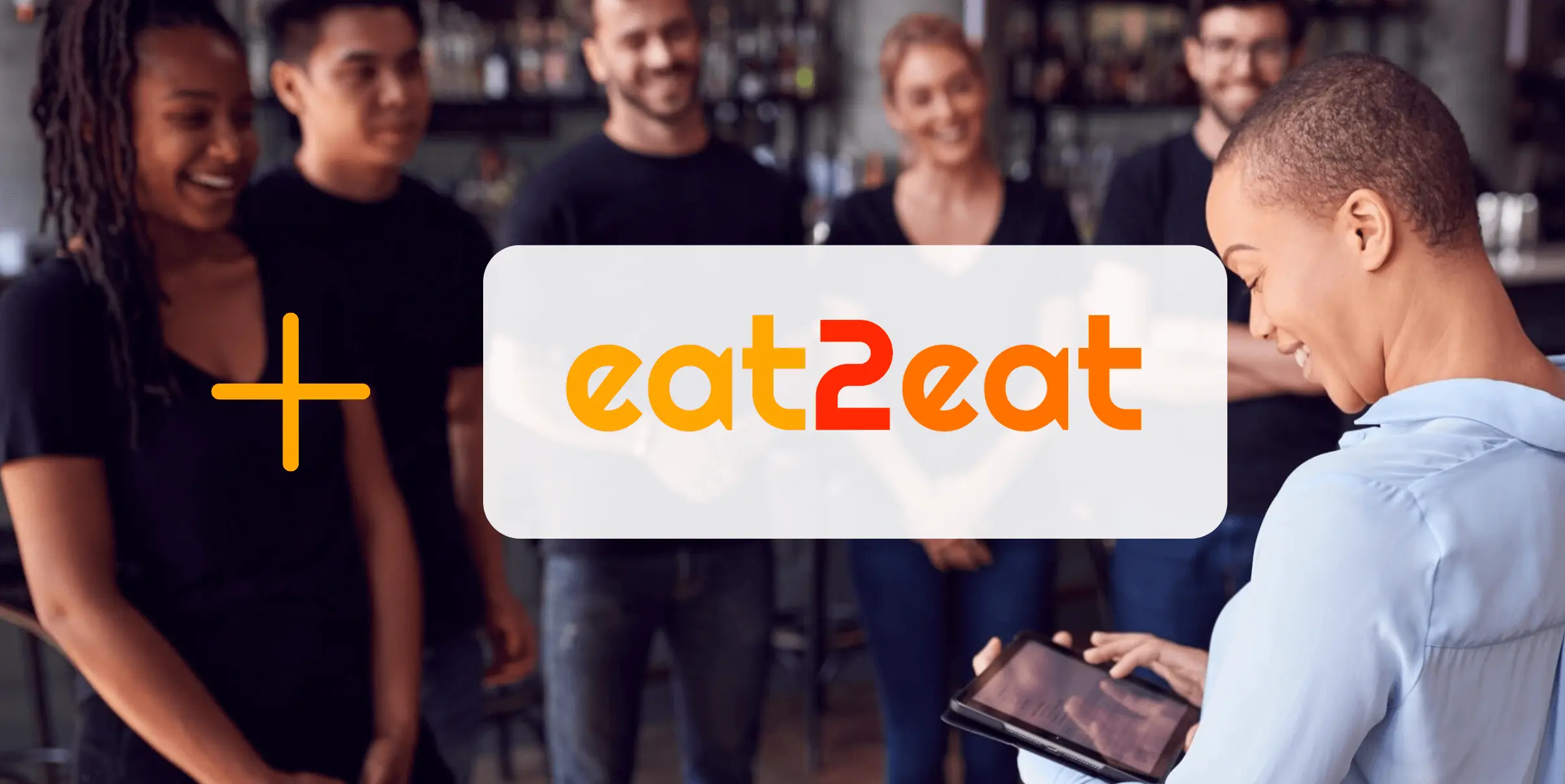 Mozrest - Solutions for Booking Channels - Group of friends seating at a table in a restaurant searching for a their next place to eat on their mobile phone